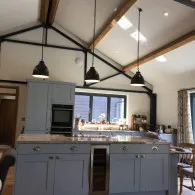 Home fitted with blue kitchen with long black drop down lights, Lakenheath